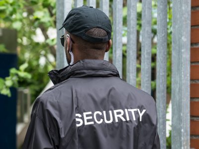 Rear View Of A Security Guard Rear View Of A Male Security Guard Wearing Black Uniform
