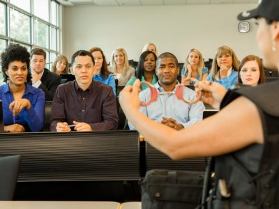 law-policewoman-speaks-to-police-cadets-in-classroom-handcuffs-picture-id486148228 law-policewoman-speaks-to-police-cadets-in-classroom-handcuffs-picture-id486148228